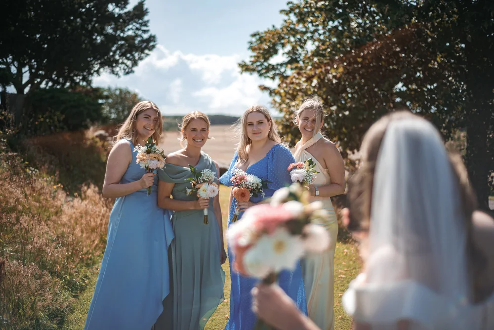 Bridesmaids holding bouquets