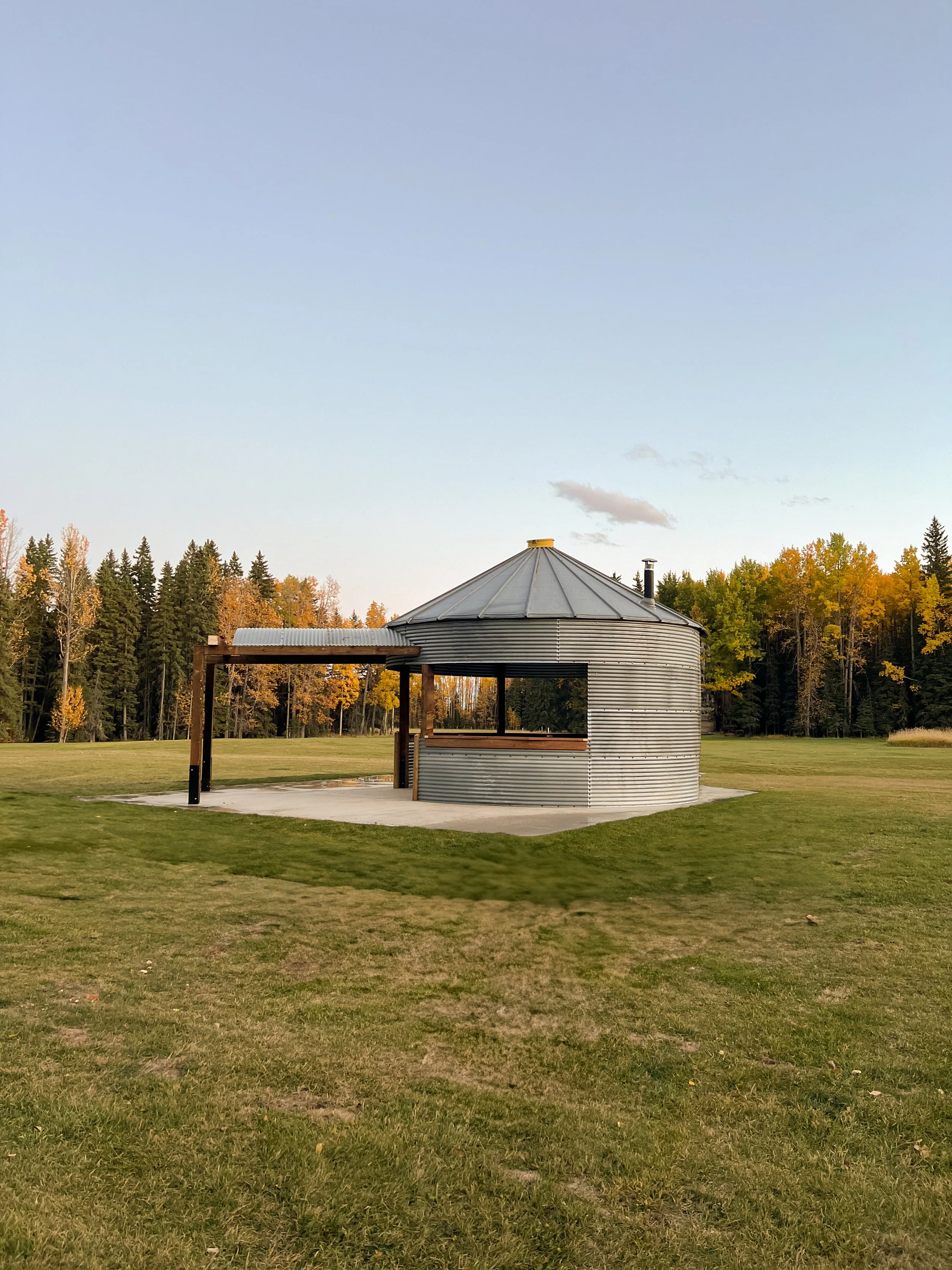 Reclaimed granary on a cement pad in a five-acre clearing with grass all around