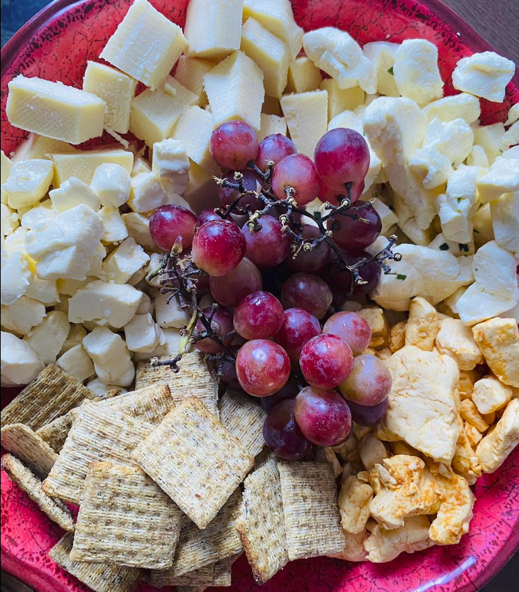 cheeseplate with crackers, grapes and cheese curds