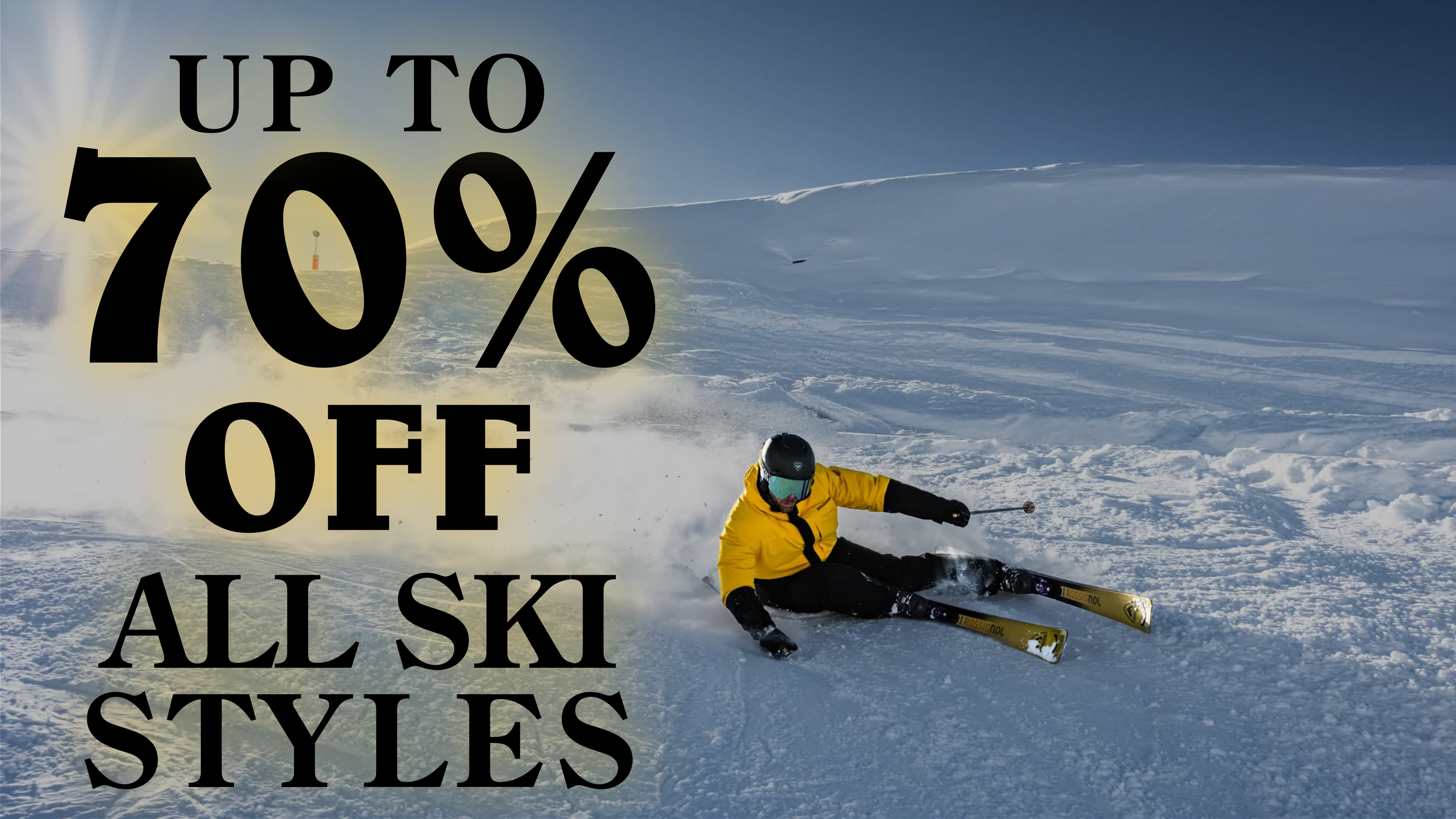 A skier in a yellow jacket and black pants falling on snow in a snowy mountain landscape with skis and helmet, overlaid with bold black text stating 'Up to 70% off all ski styles'.