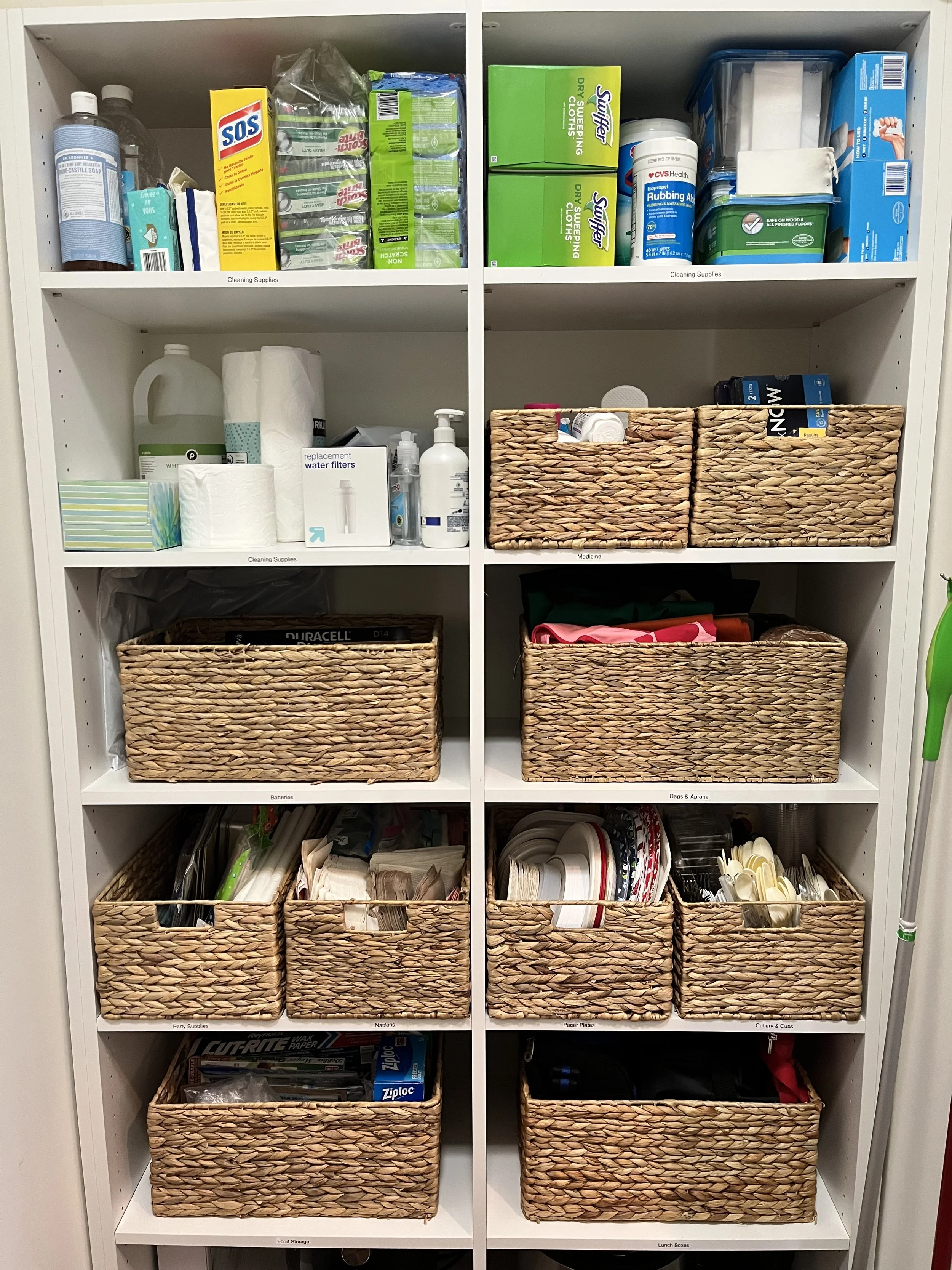 Organized pantry in Atlanta, with white shelving containing curated labeled baskets. Happy Tree Organizing uses products that are beautiful and long lasting, to keep you organized for a long time. 