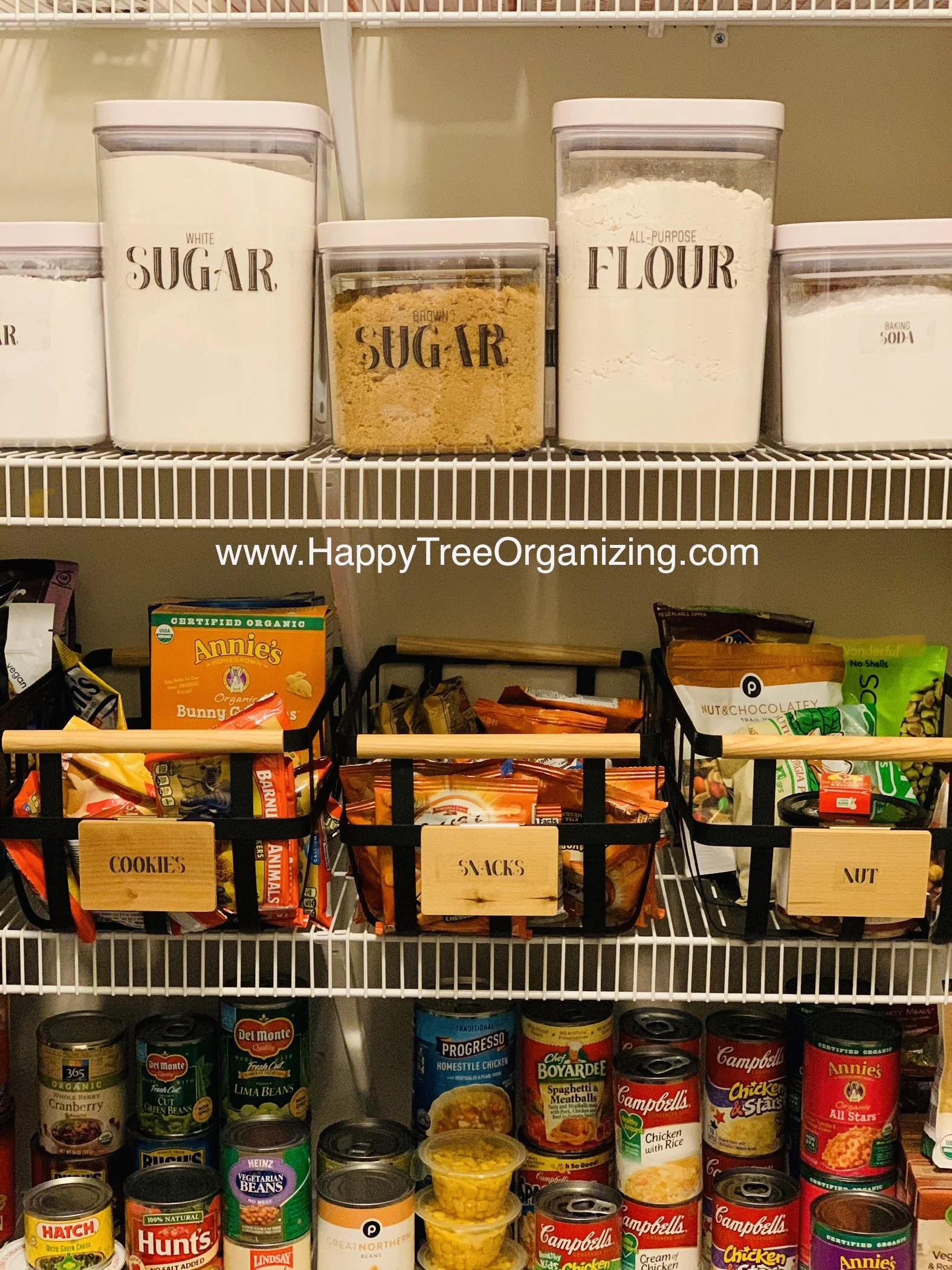 Organized Kitchen pantry in Decatur, GA with labeled containers of sugar, flour, and baking soda, along with snack and canned food items below.