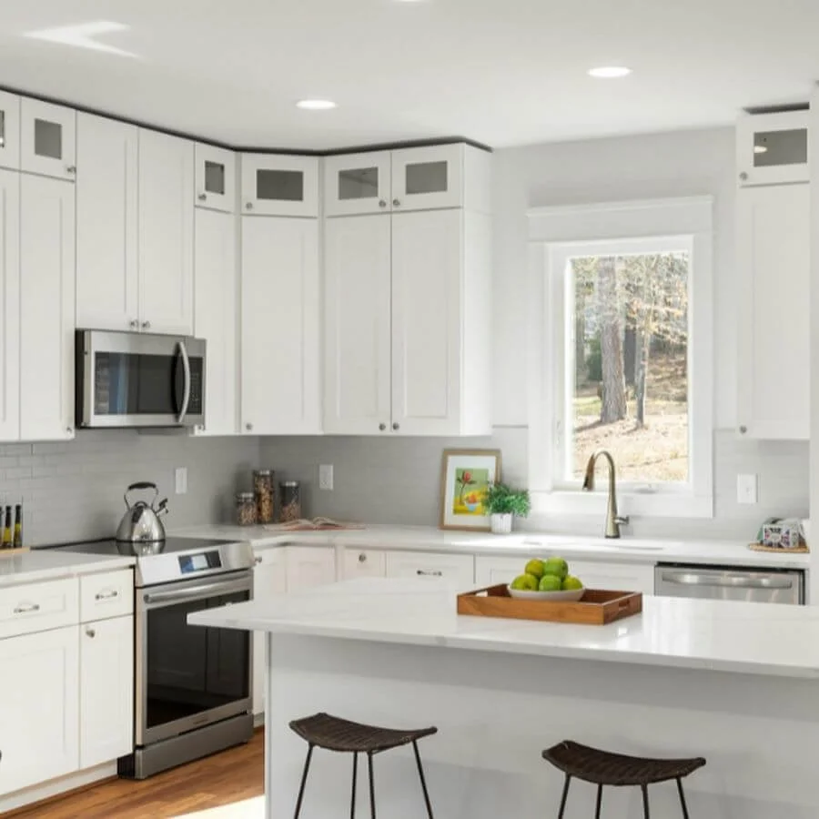 Simplified kitchen space with clear countertops, white cabinetry, and an uncluttered layout designed for easier everyday living.