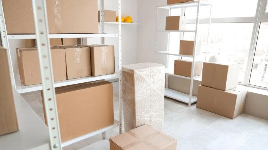 Decluttered storage space with shelving, neatly stored boxes, and clear floor space for easier access and organization.