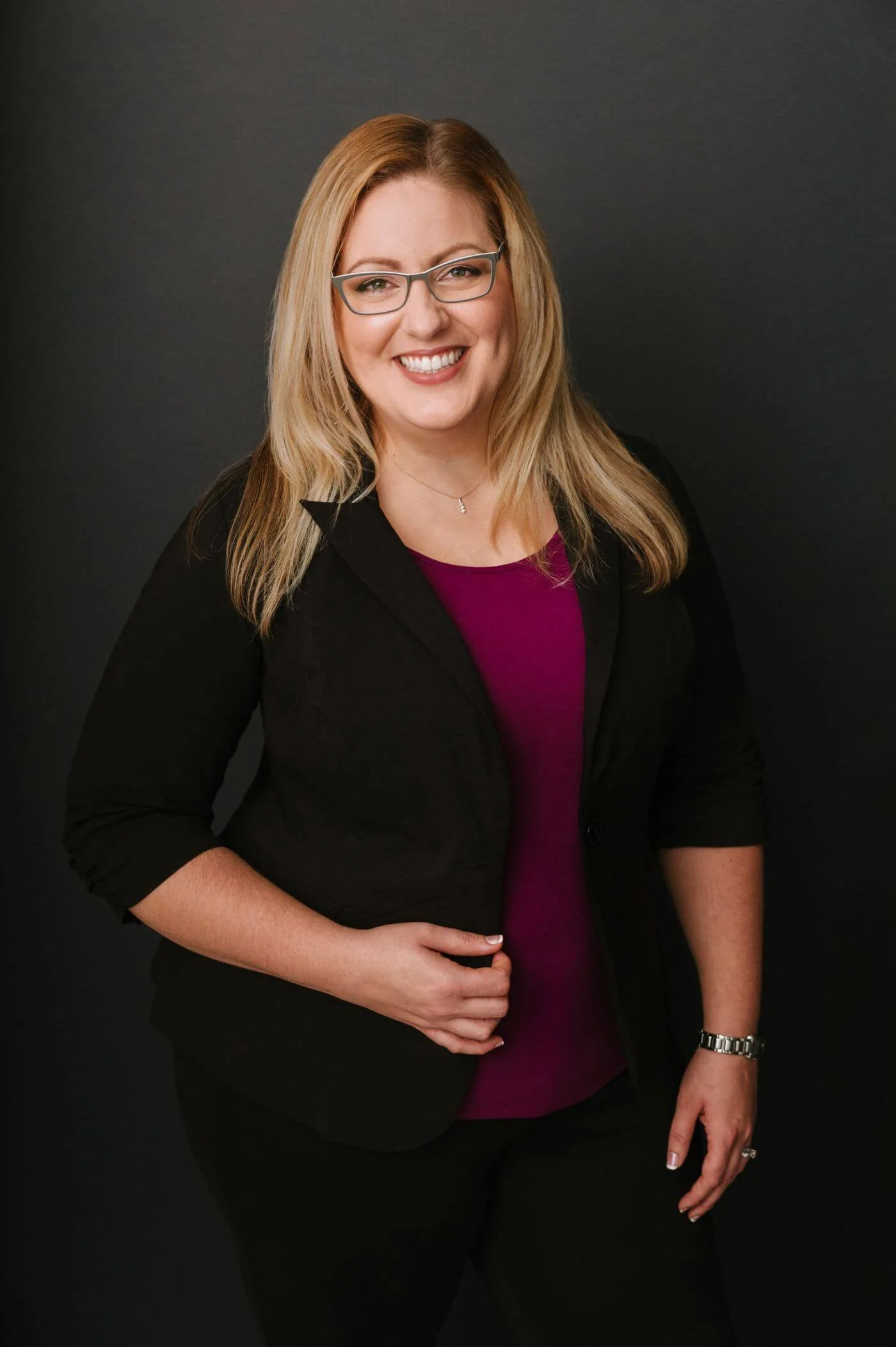 Aleah Duitsman, professional organizer, smiling warmly in a portrait with a friendly and approachable expression.