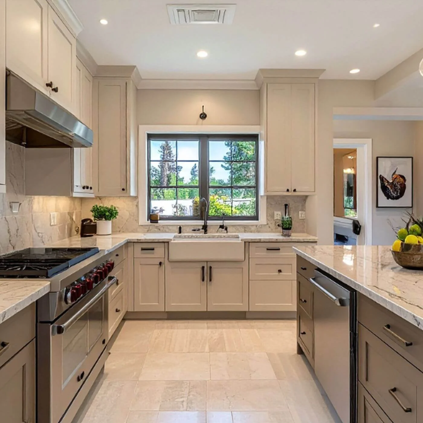 Organized kitchen with cream cabinets, black hardware, a farmhouse sink, and clear countertops.