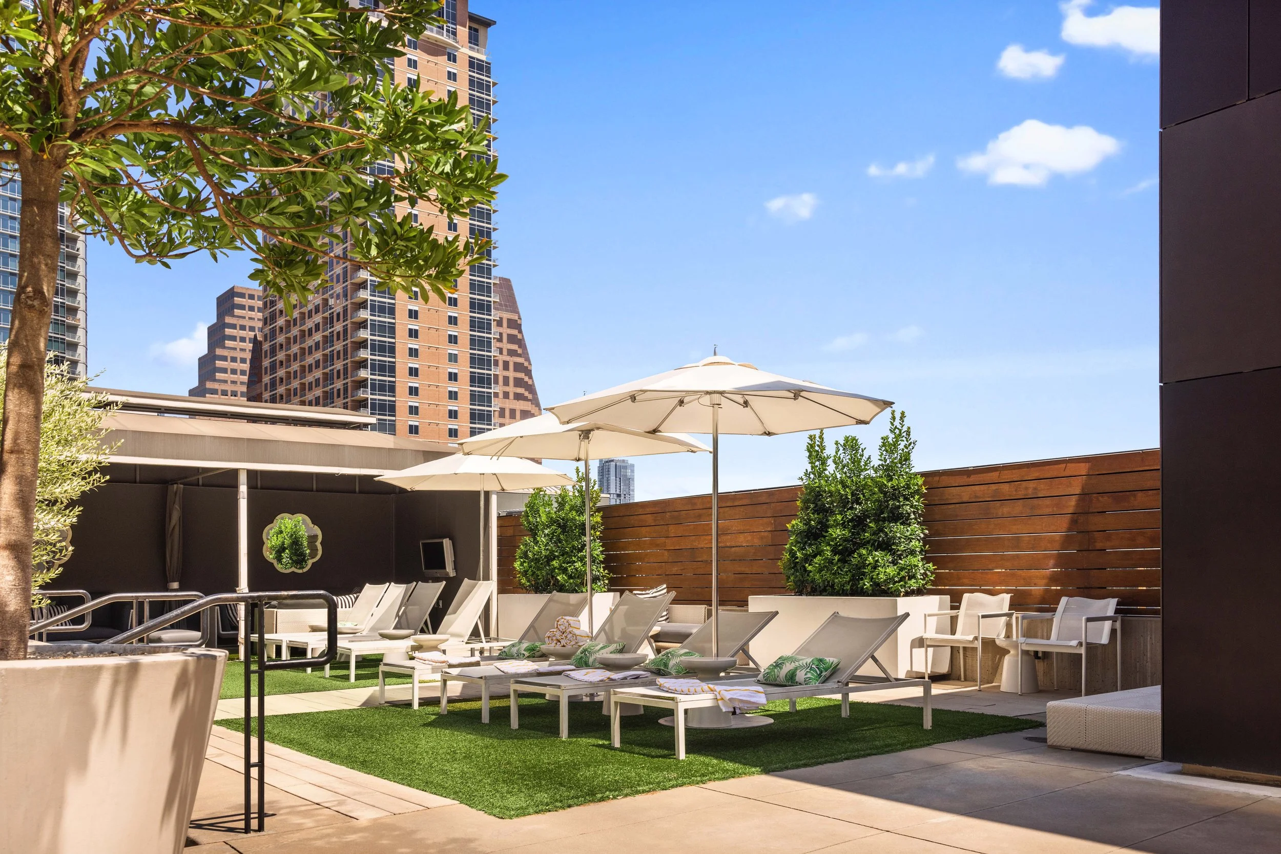 An exterior commercial architecture and real estate image for the W Austin Hotel featuring their lounge chairs on a rooftop deck