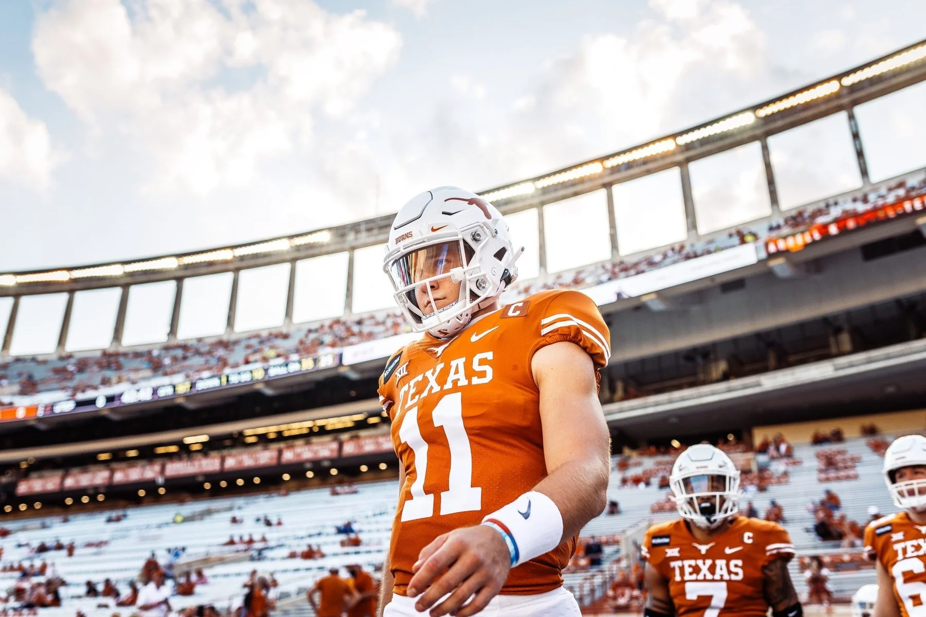 A dramatic portrait of starting quarterback Sam Ehlinger walking out on to the Texas Football field for a college football game