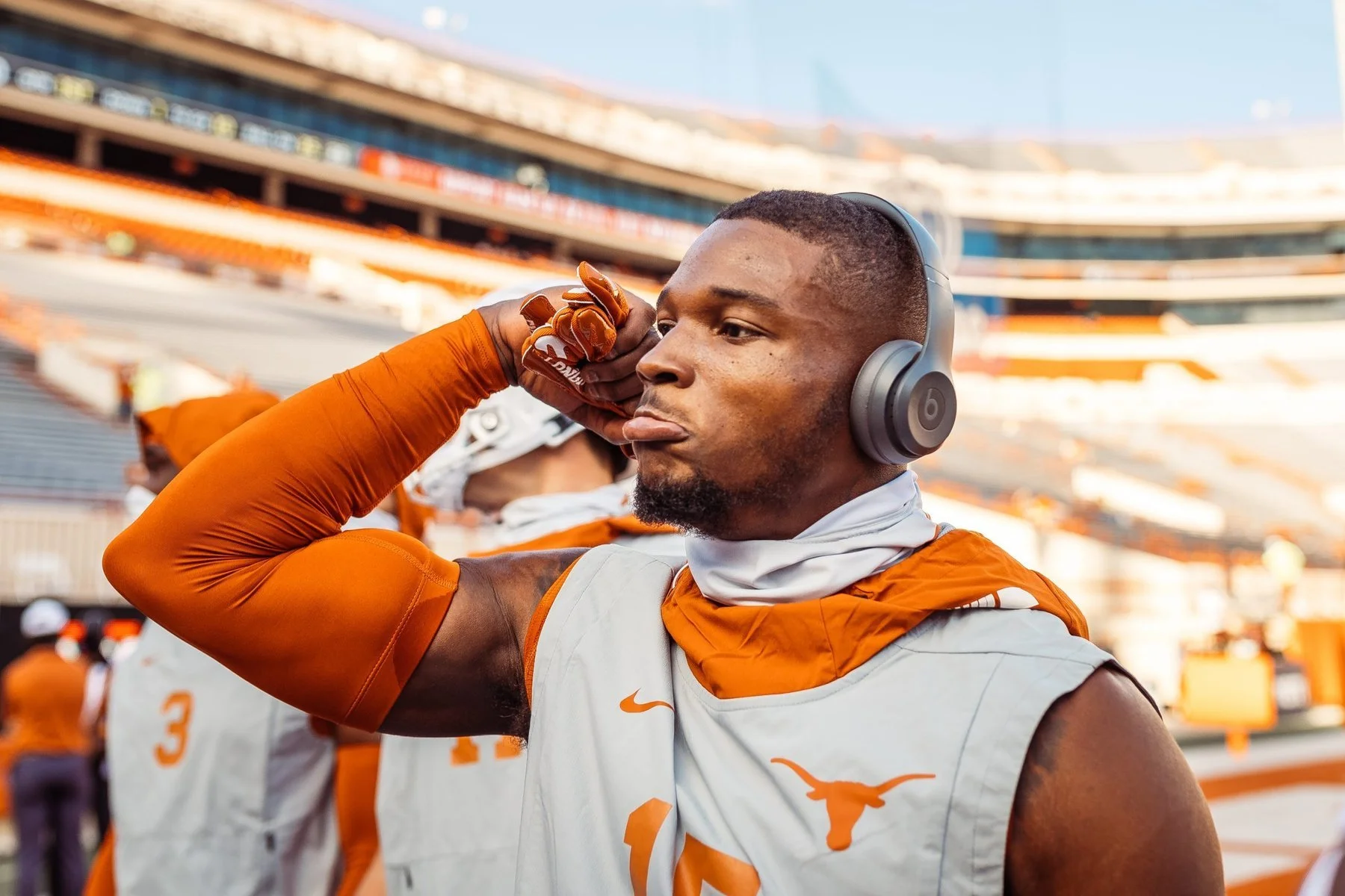 A sports portrait of a Texas Football Player getting ready before a college football game wearing Beats headphones in Austin, Texas