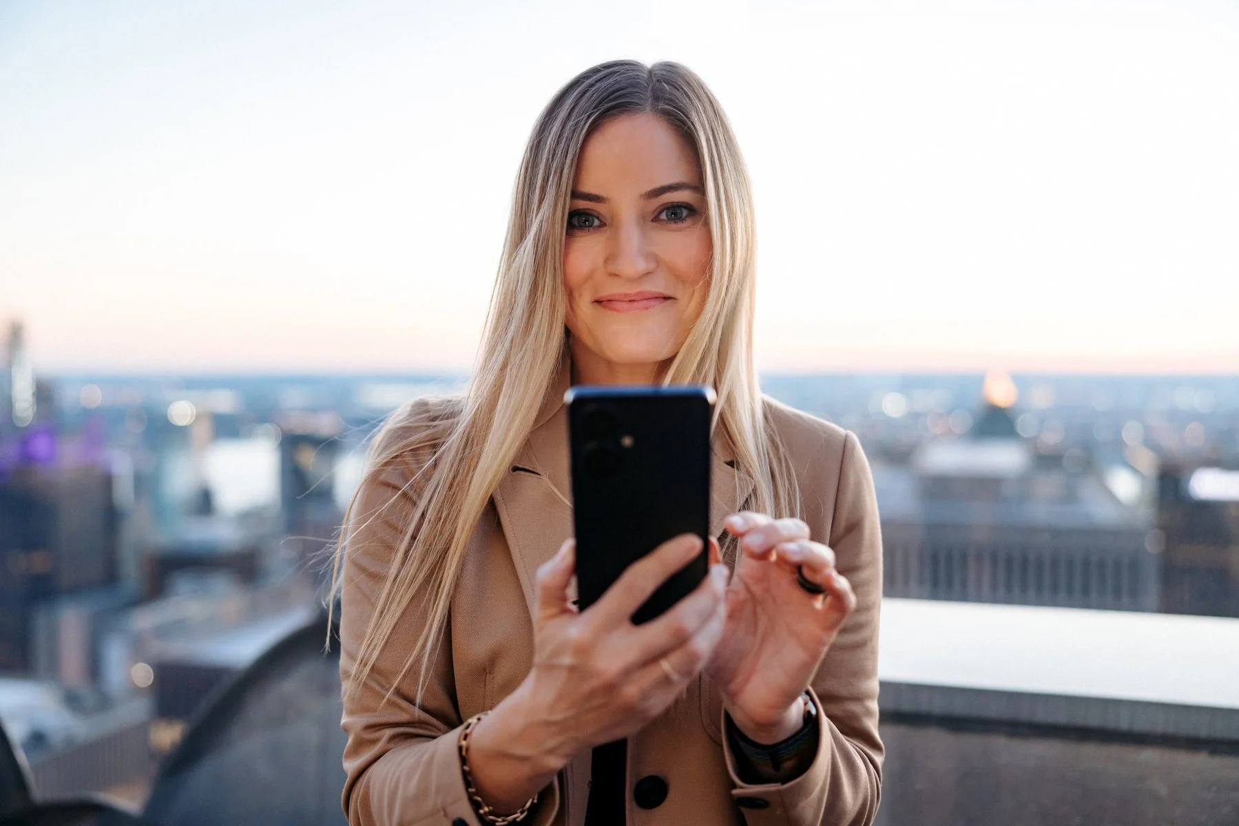 A portrait of iJustine on the rooftop of the Rockefeller center in New York City for a new phone launch from the tech company TECHNO Mobile