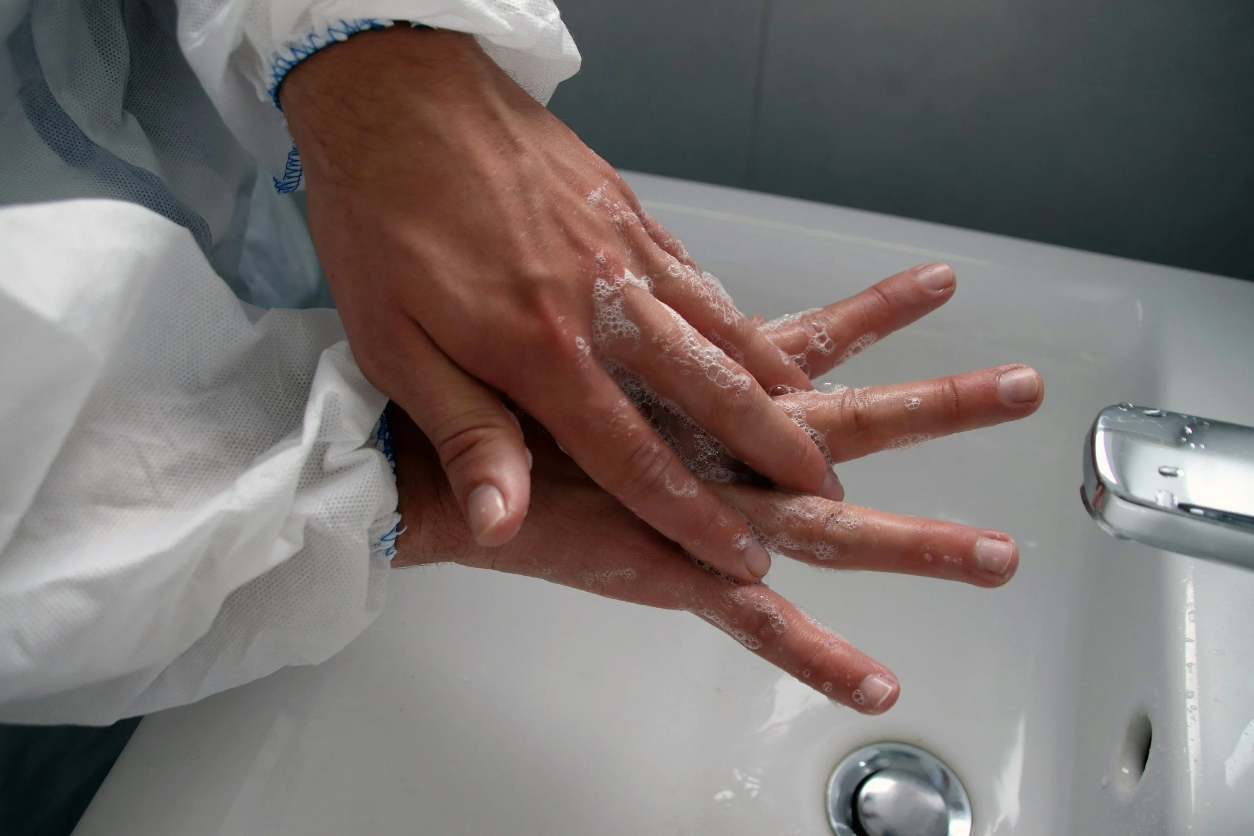 Physician washing hands in a hospital setting, reflecting infection control and OCD-related concerns