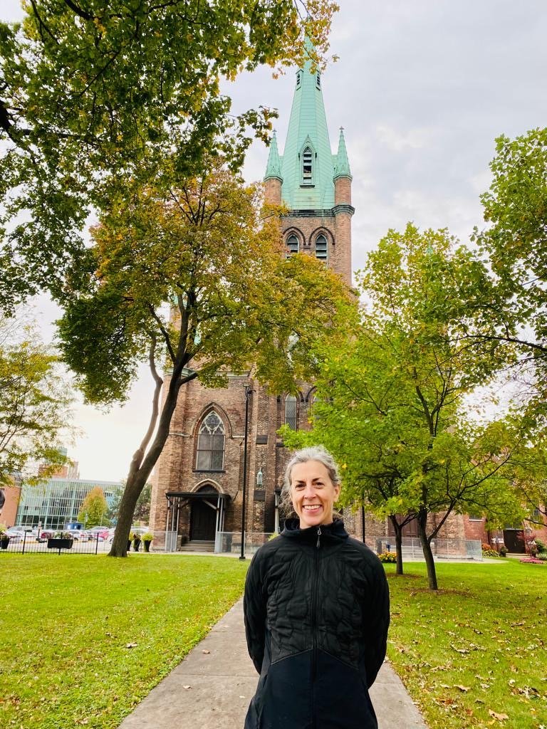 Lori LeMare stands in front of Our Lady of Assumption church