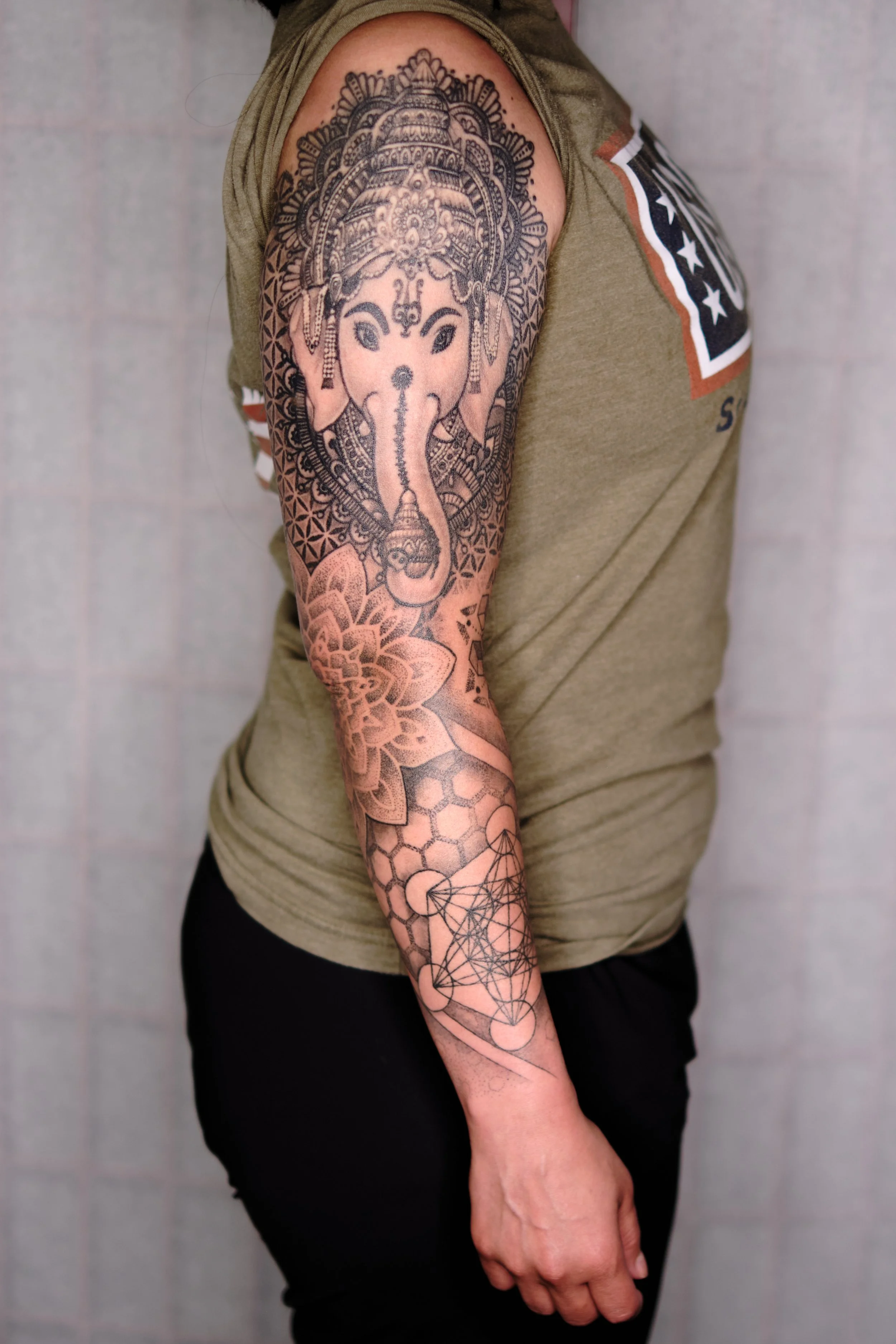 Geometry arm sleeve tattoo with a mandala elbow (photo 2 years healed)