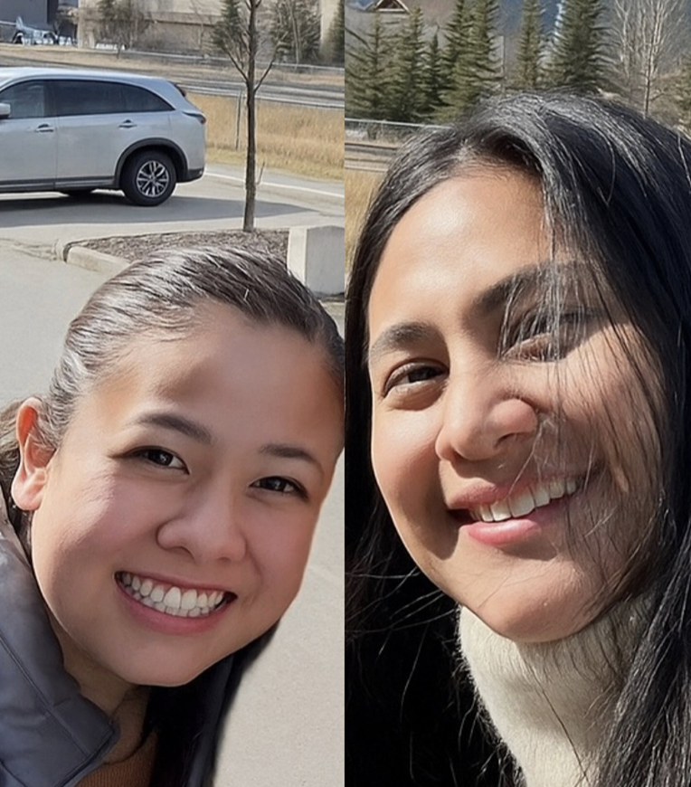 Two women smiling outdoors on a sunny day with trees and a parked car in the background.