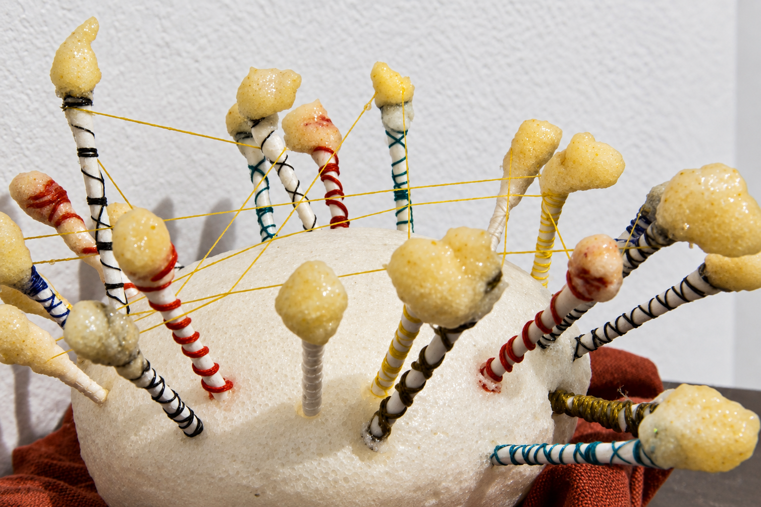 interchange . 2016 . ceramic, cotton swabs, resin, thread, foam, fabric, batting, parchment paper, upholstery tacks