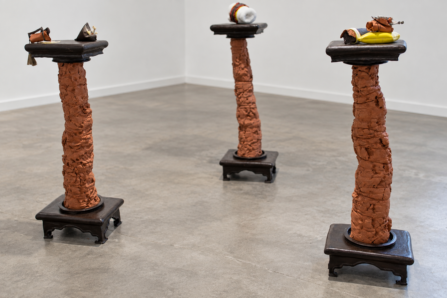 Terracotta Pedestals in a Minimalist Gallery.png