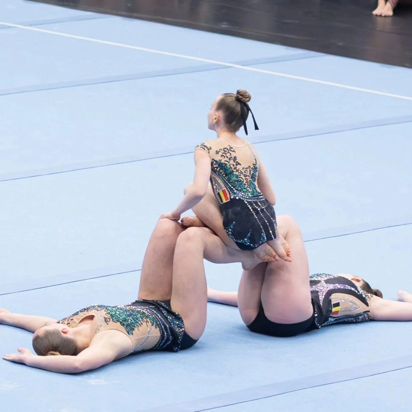 Foto acro trio in danspose met een pak van Atelier Nadja & Tutti Leotards