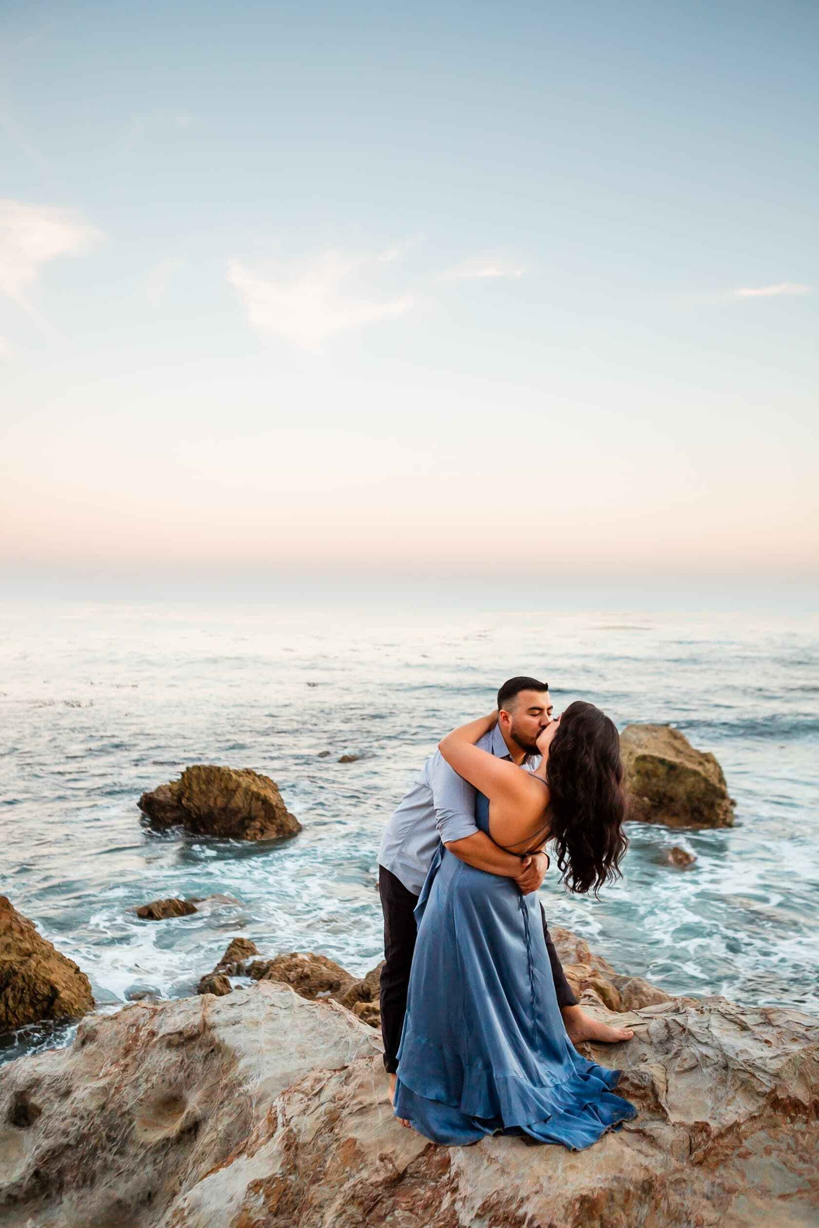 dramatic photo at Heisler Park in Laguna Beach by the ocean kissing