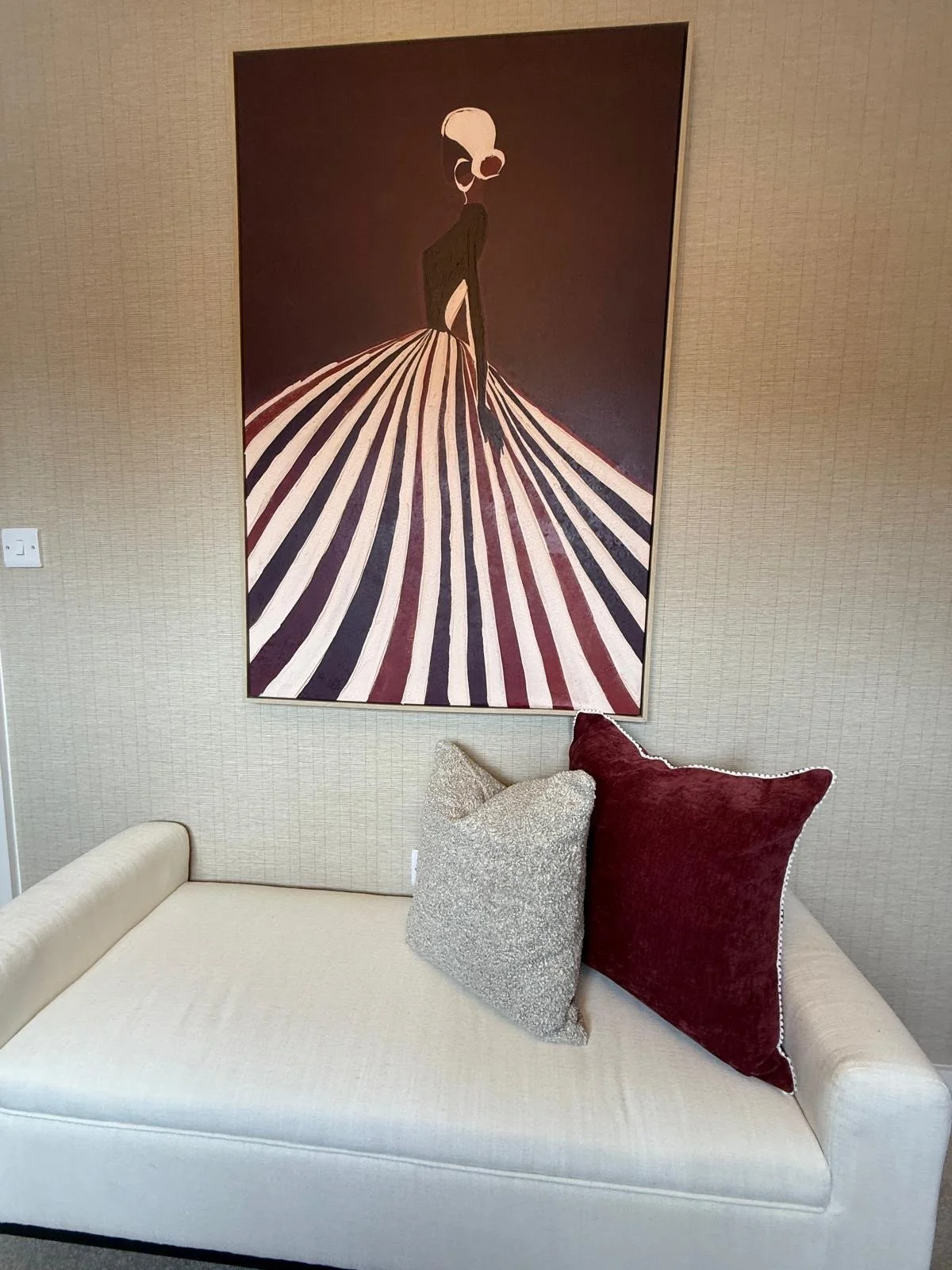 Show home principal bedroom at Hafan y Glyn, Colwyn Bay, with alabaster globe chandelier, wave curtains and layered cream and damson bedding
