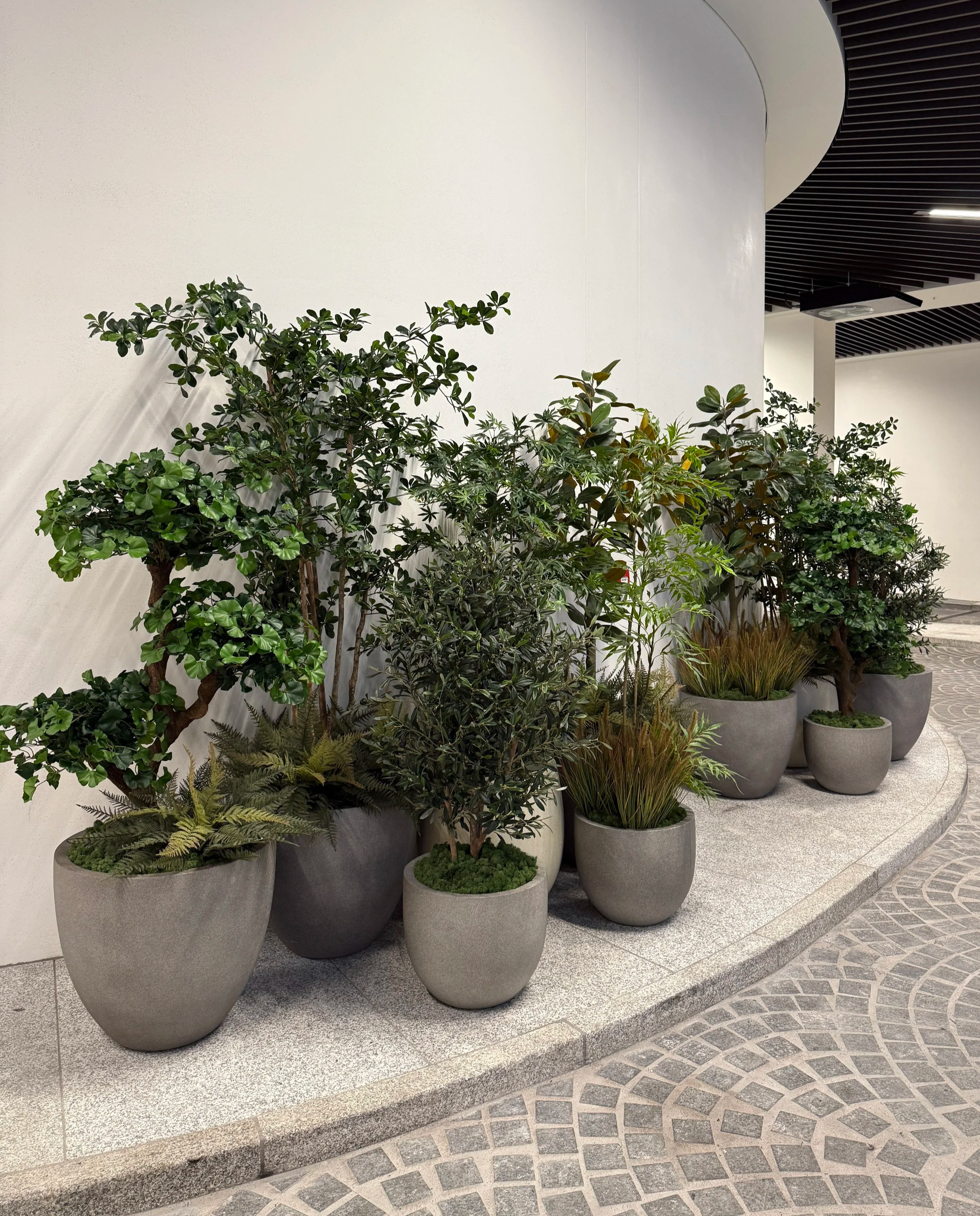 Indoor potted artificial plant and tree display for commercial space The Whiteley in Queensway London
