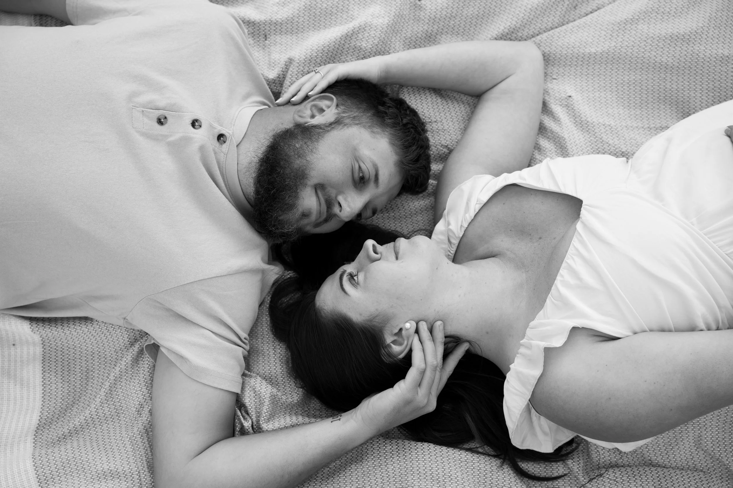 couple laying in field on picnic blanket during engagement photo session at Honey Hill Farms in Mayfield Kentucky