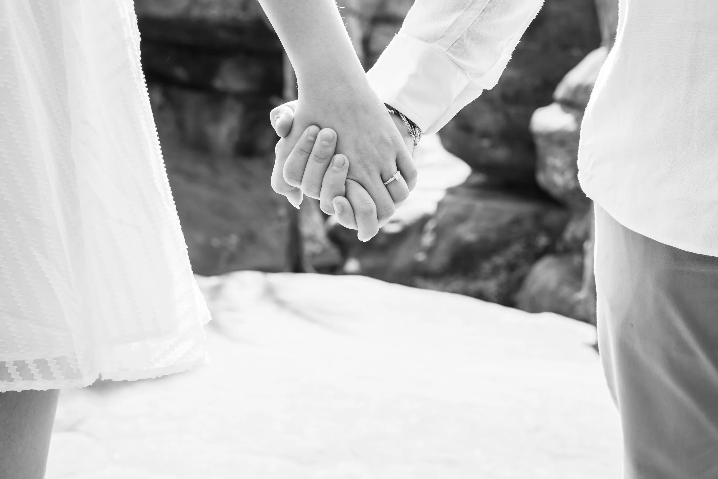 Couple holding hands displaying engagement ring during engagement photo session at Garden of the Gods in Southern Illinois