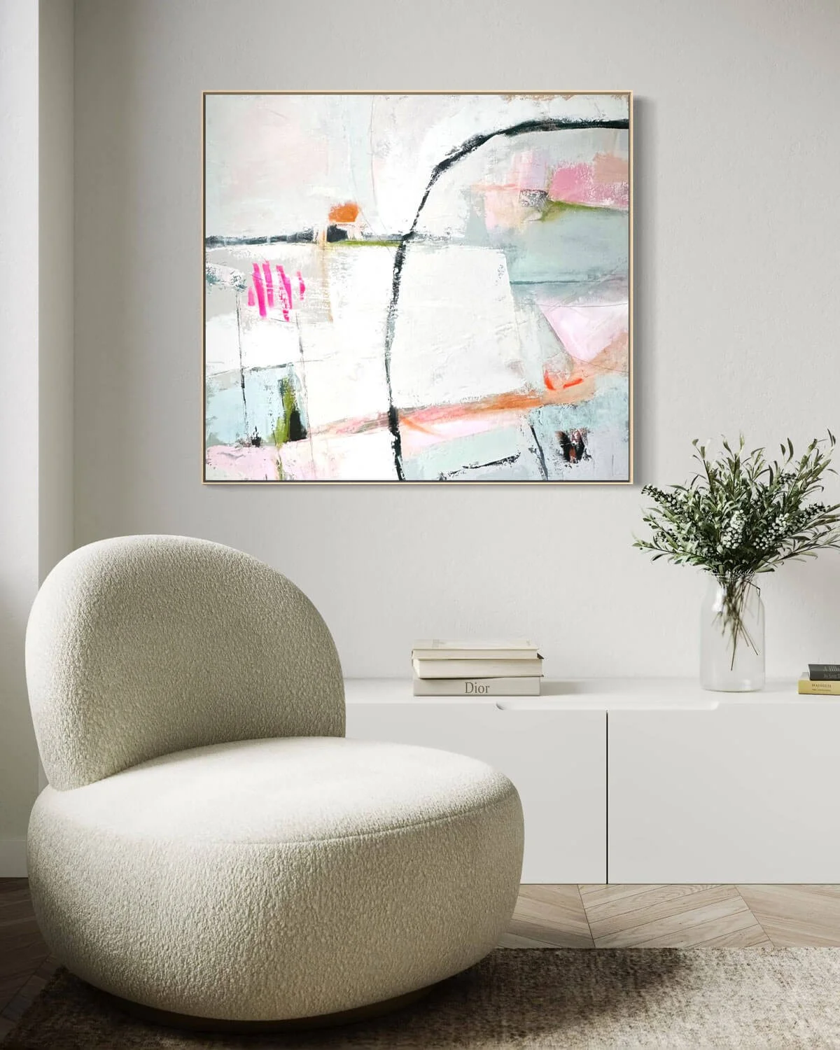 Square abstract painting titled Free to Be hanging in white room