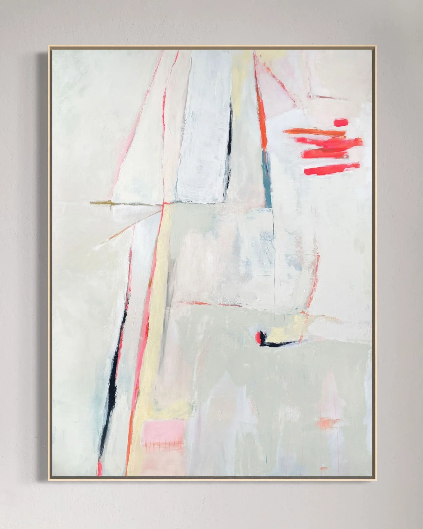 Abstract painting with light colors, strokes of black and bright red on a white background, framed on a light grey wall.