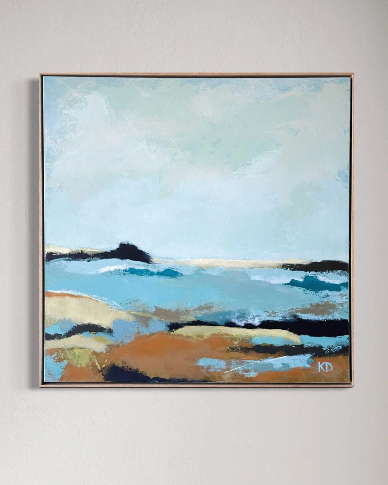 Abstract landscape painting of a beach with blue water, sandy shore, and distant landforms, signed at the bottom right corner.