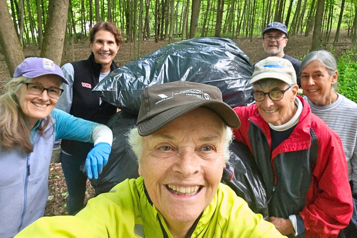 Smiling woman in yellow shirt with five people behind her