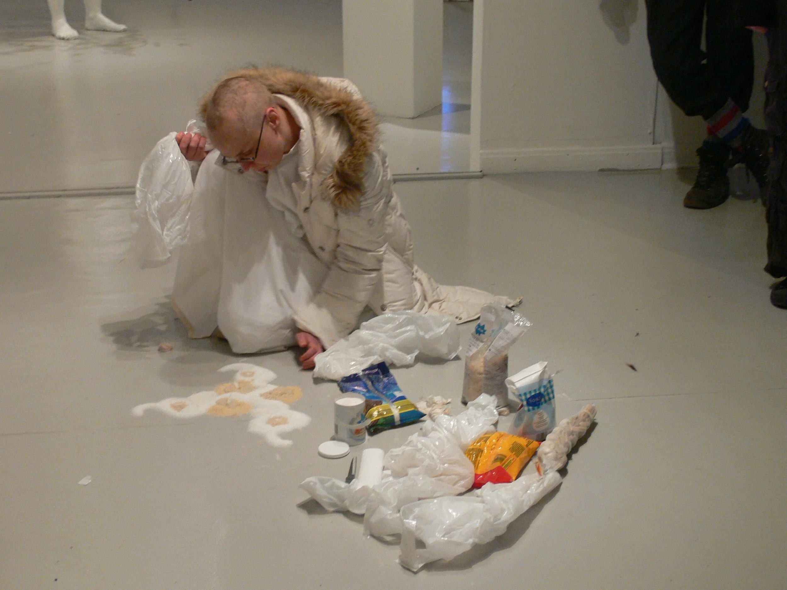 Woman starting to build a mandala out of white food stuff. 
Photo by: Simo Saarikoski