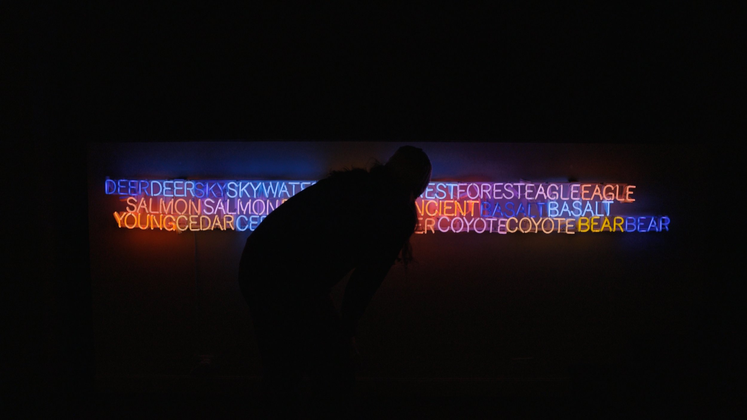 Matt Dilling from Lite Brite Neon inspecting Marie Watt's 'Shared Horizon" neon piece