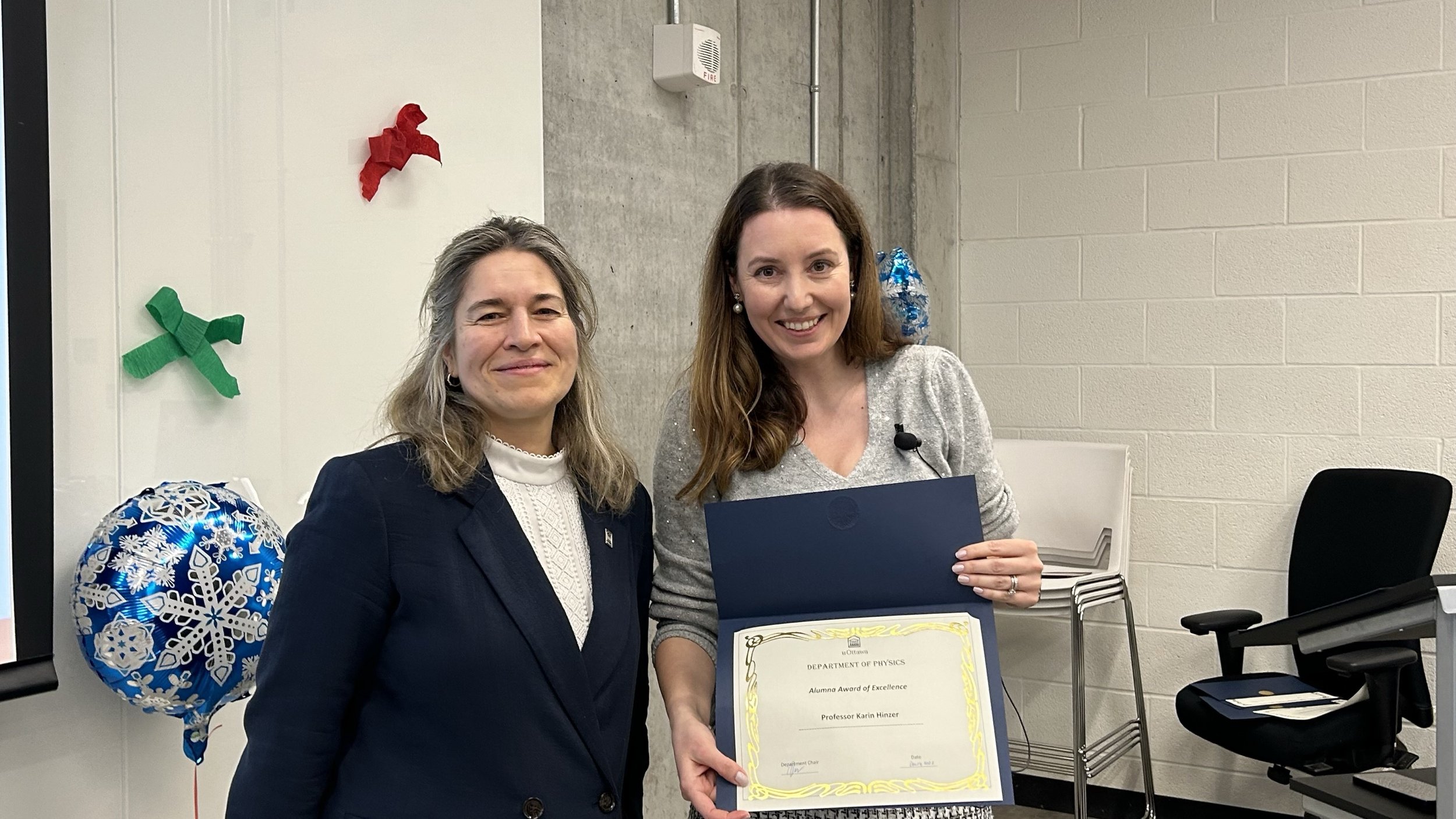 2023.12.14 Karin receiving Alumna Award of Excellence from Adina.png