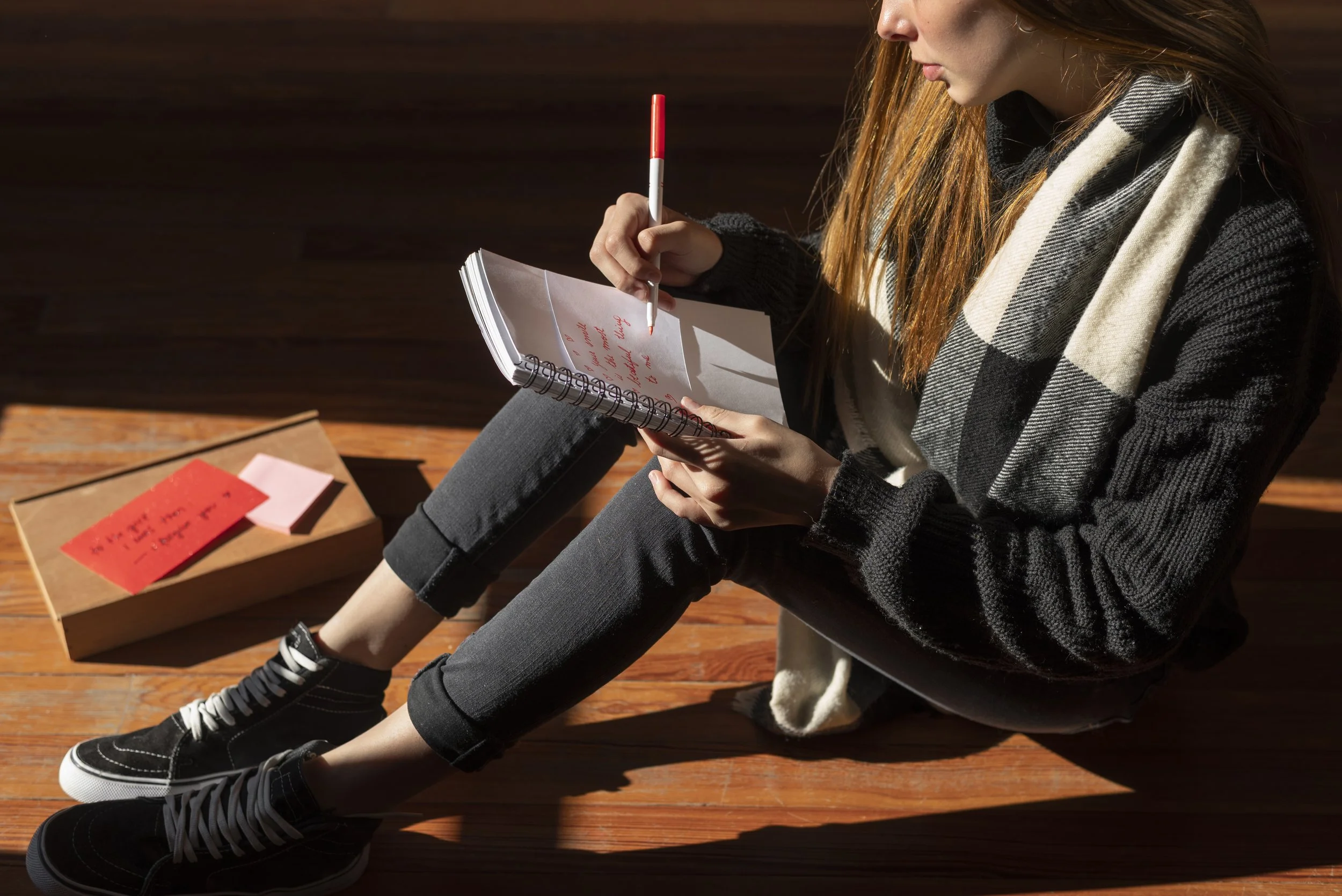 A woman writing on her notebook - Healing Family Addiction