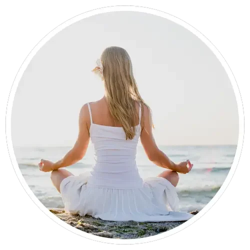 Woman meditating on beach, getting better in outpatient alcohol treatment - Healing Family Addiction