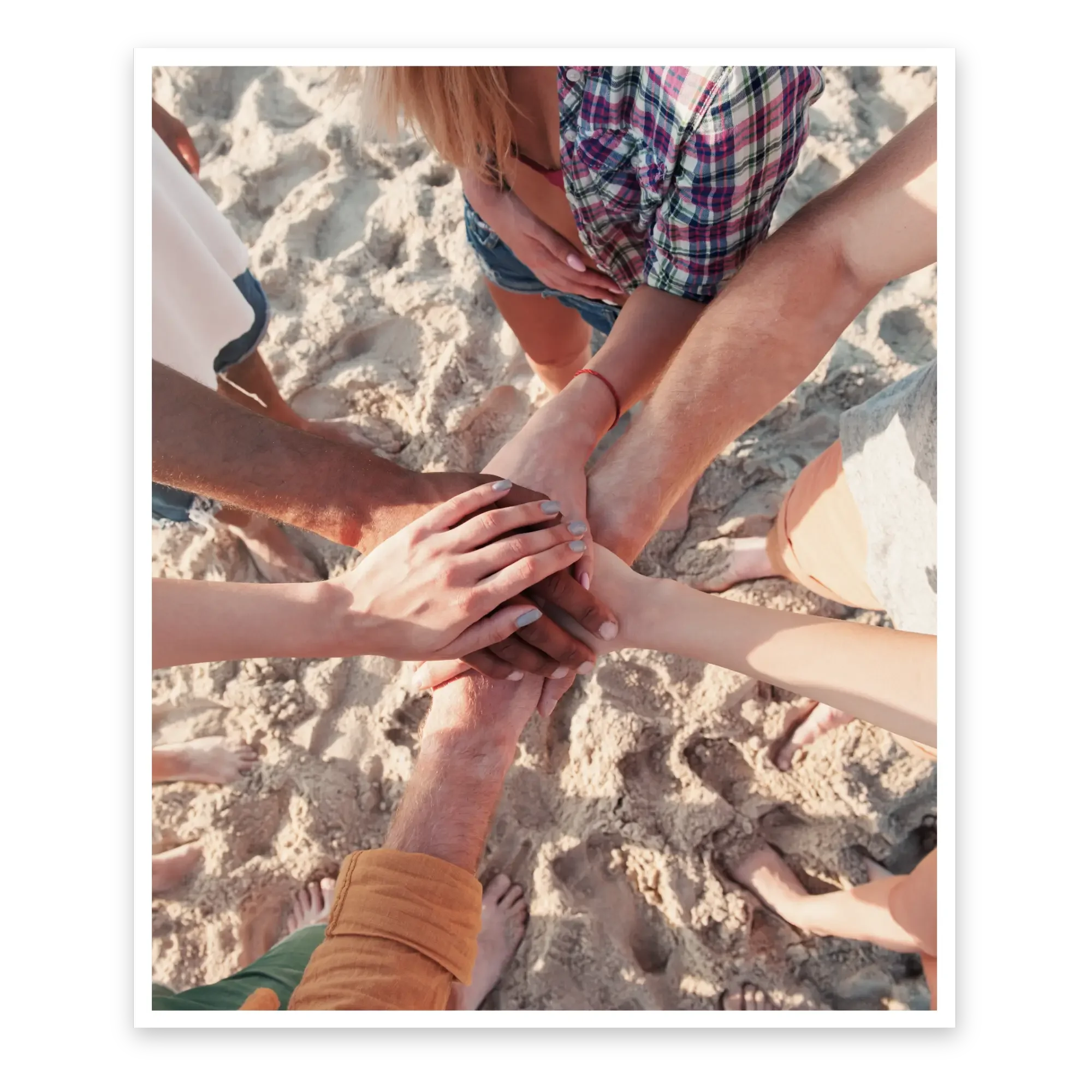 Hands layered on the beach, united in outpatient alcohol treatment - Healing Family Addiction