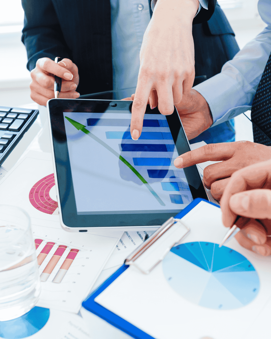 Woman point at analytics on a tablet