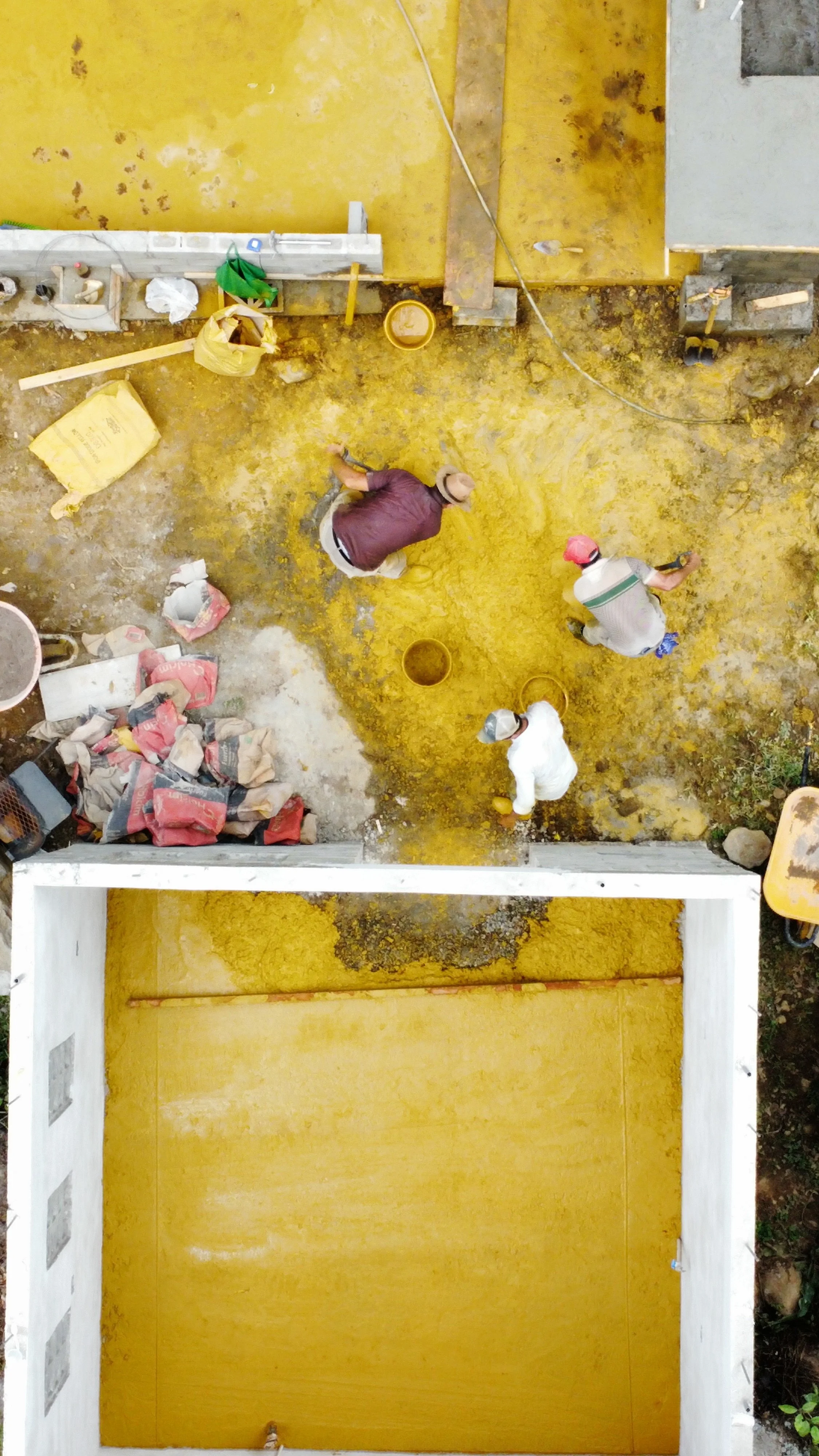 Drone photo of mixing yellow pigment into concrete at Rancho Garza in Costa Rica.