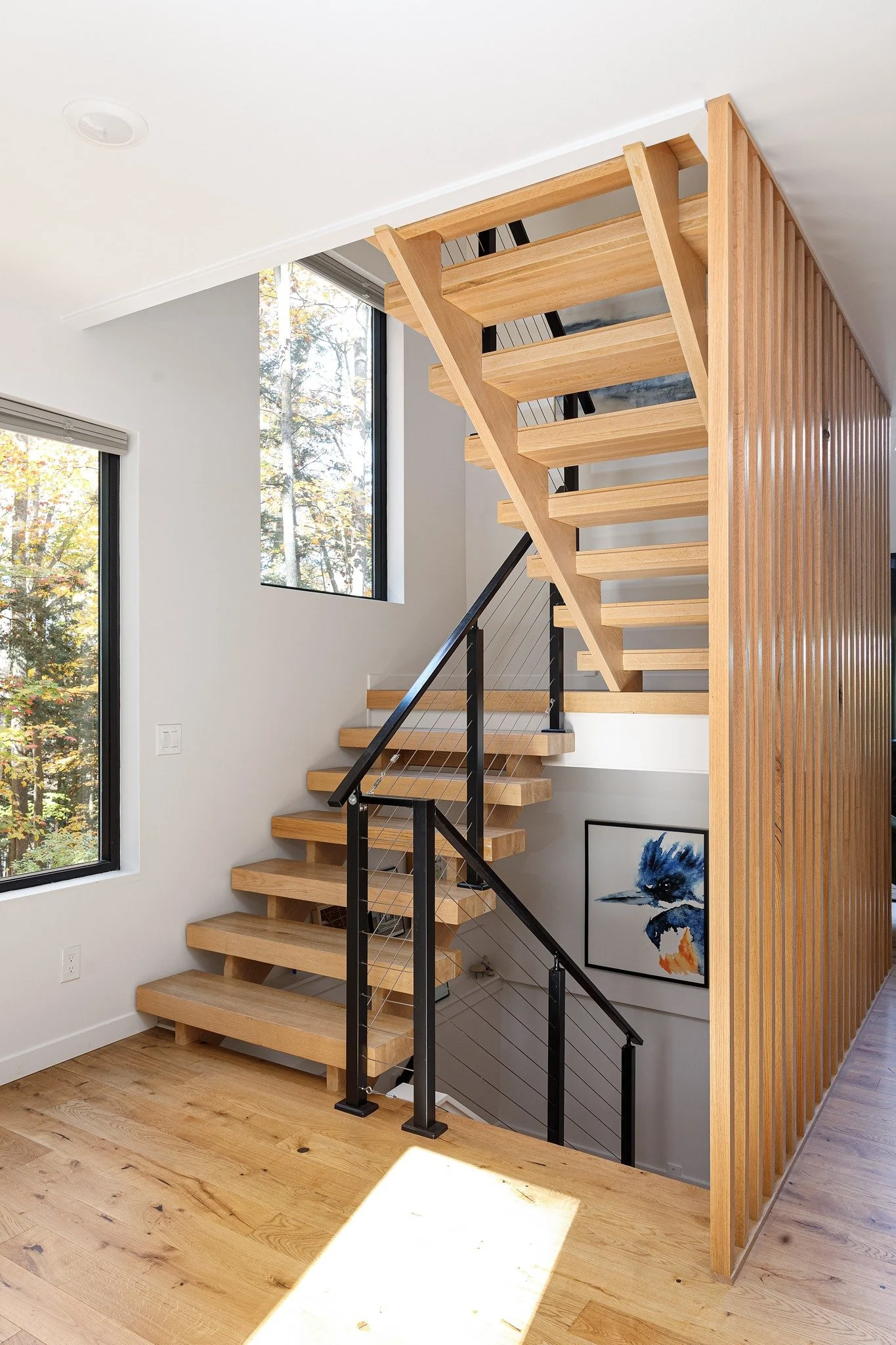 lake-house-interior-design-open-wood-staircase-slat-divider.jpg