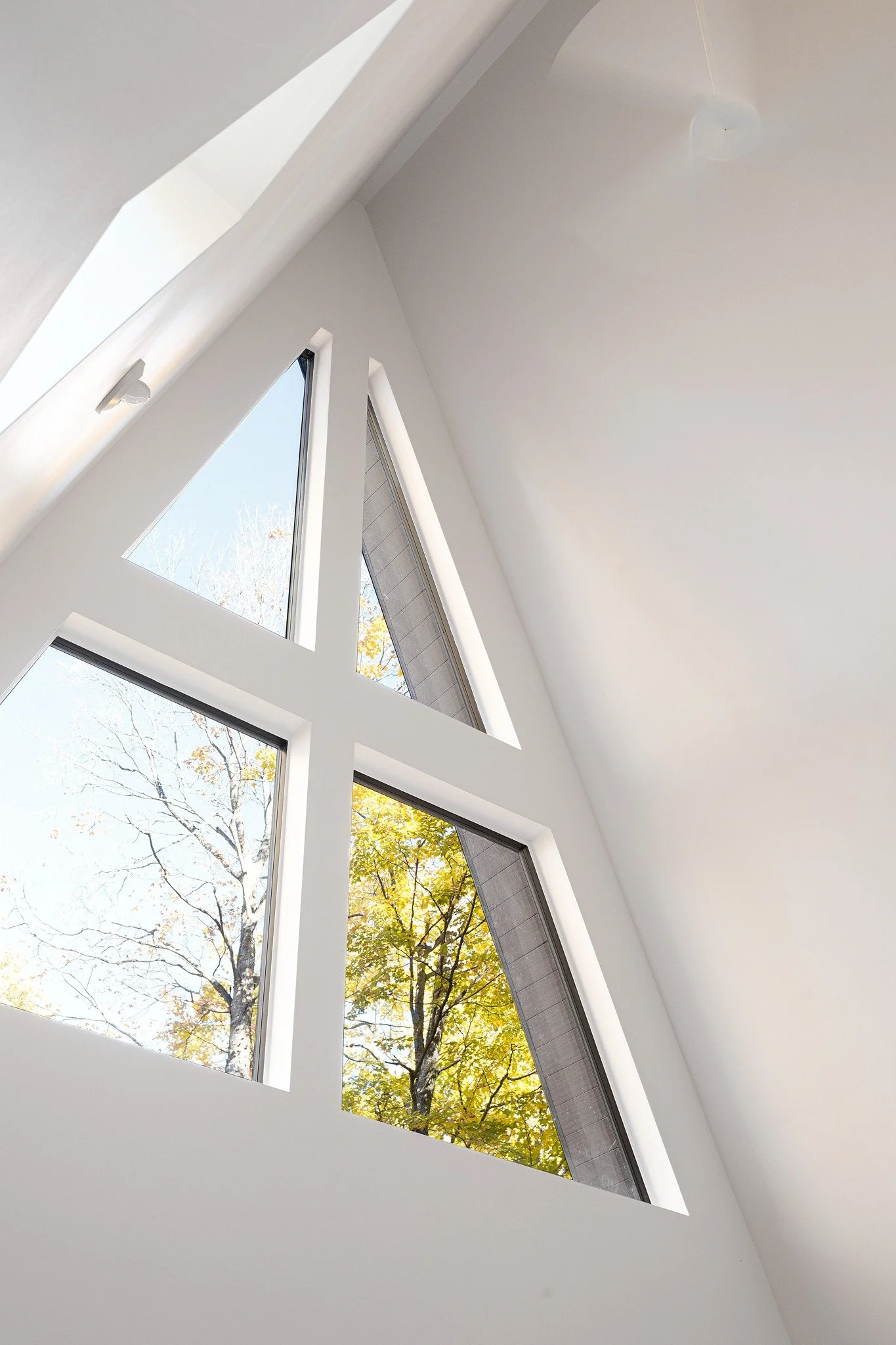 modern-lake-house-interiors-a-frame-triangular-windows-natural-light.jpg