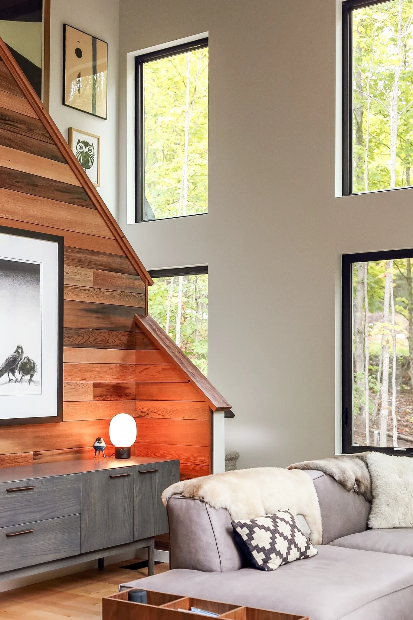 modern-lake-house-interiors-wood-stair-wall-gray-sofa.jpg