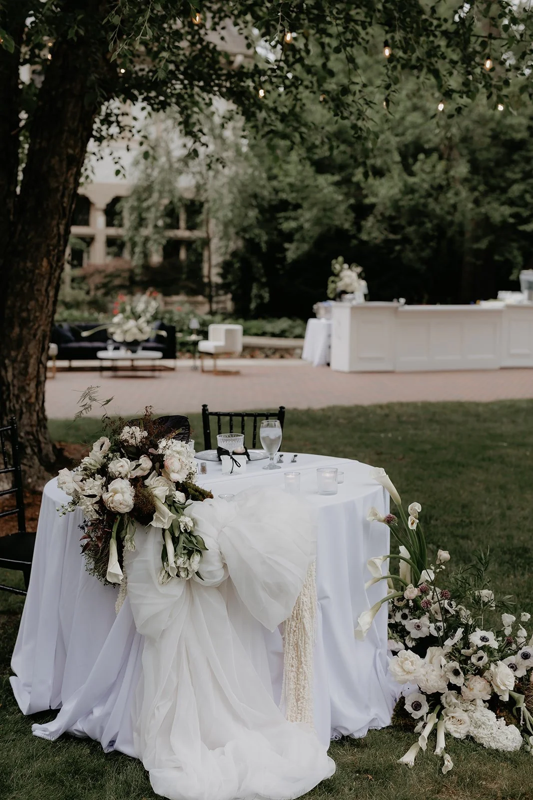 Sweetheart table with large fluffy bow and florals