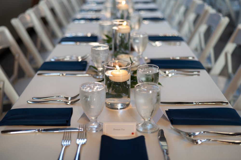 Tuscan table centerpiece featuring greenery and floating candles