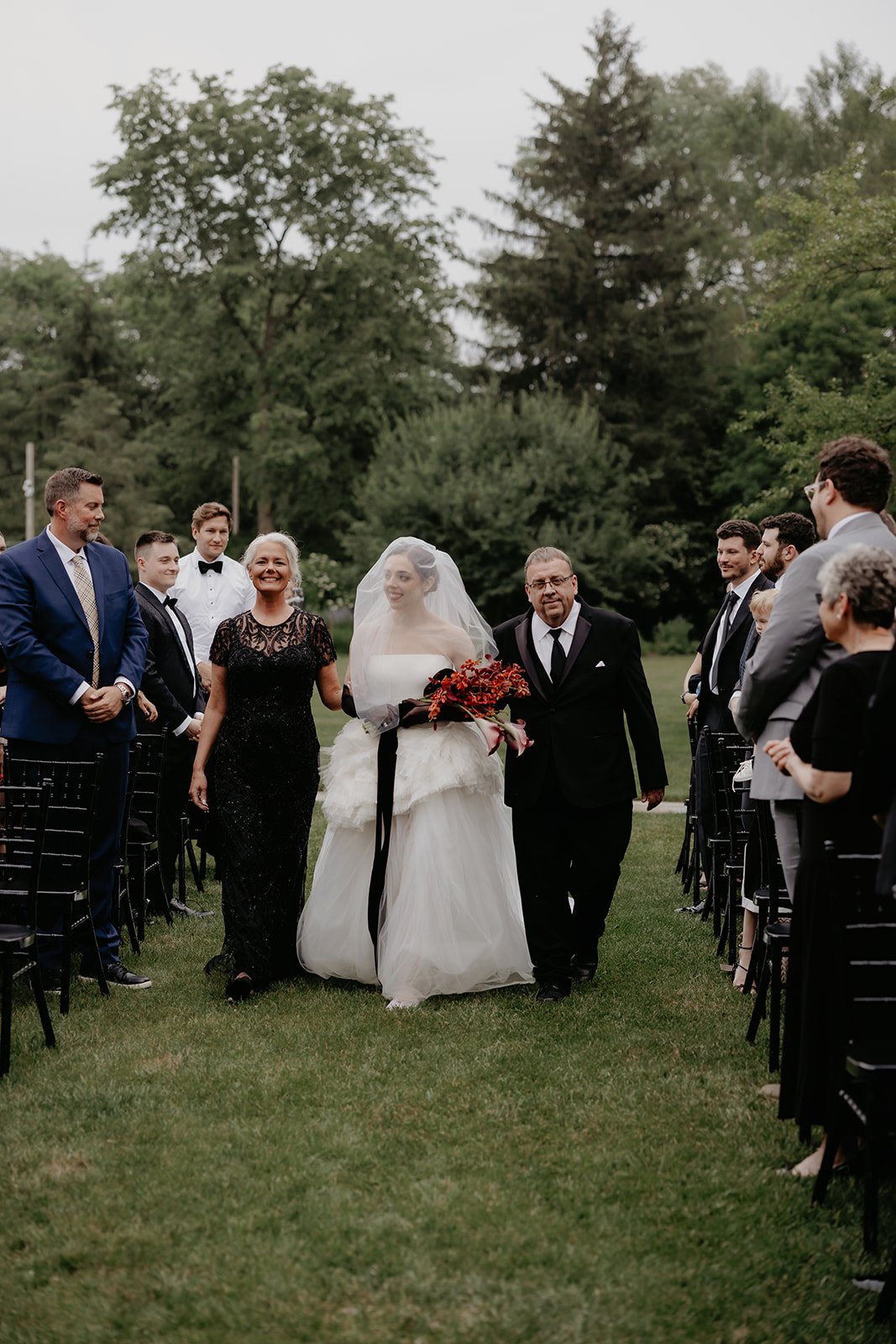 Bride enters the ceremony with both of her parents