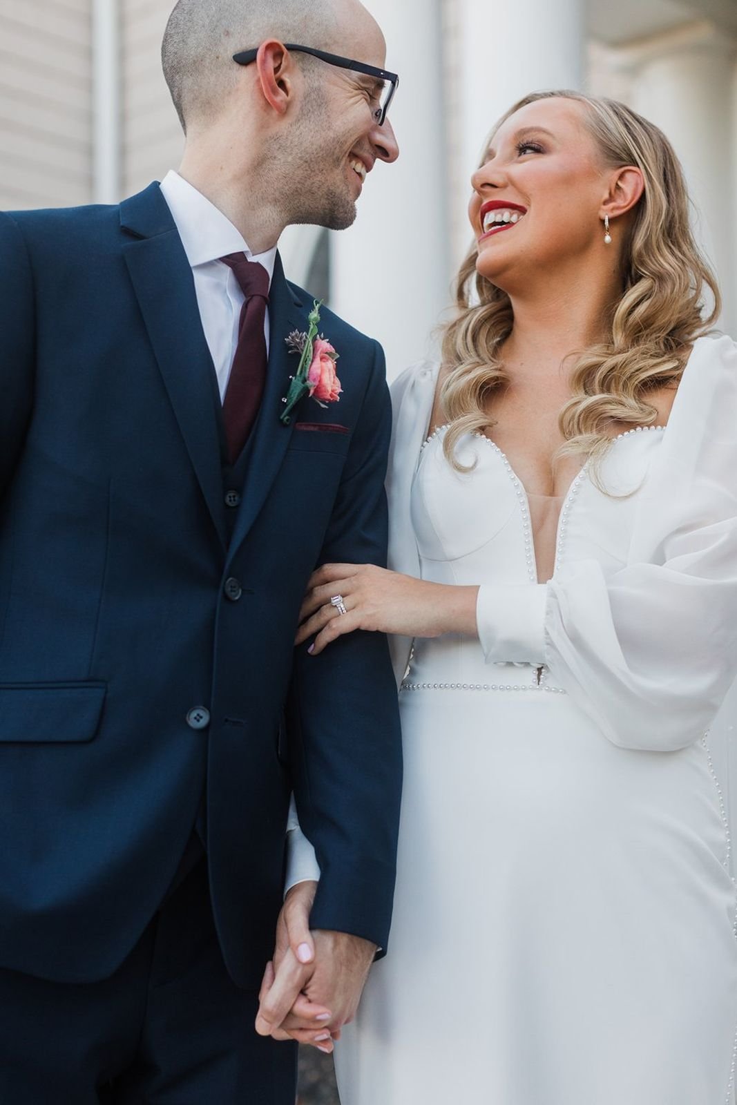 Bride and groom smiling at each other