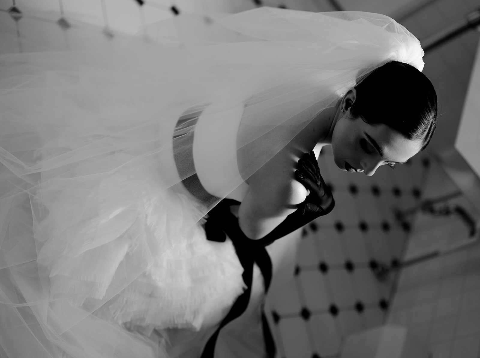 Bride against a black and white tile floor