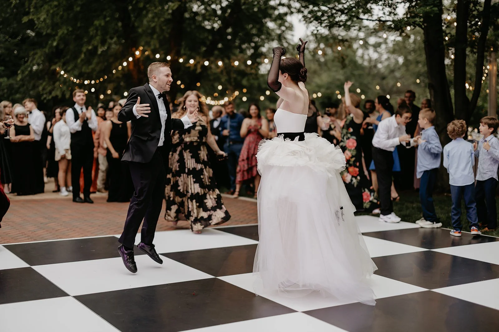 Bride and groom dancing with their guests