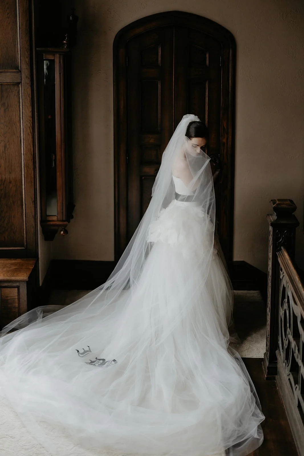 Bride's Vera Wang veil draped over her Mia gown with "I Do" on the train