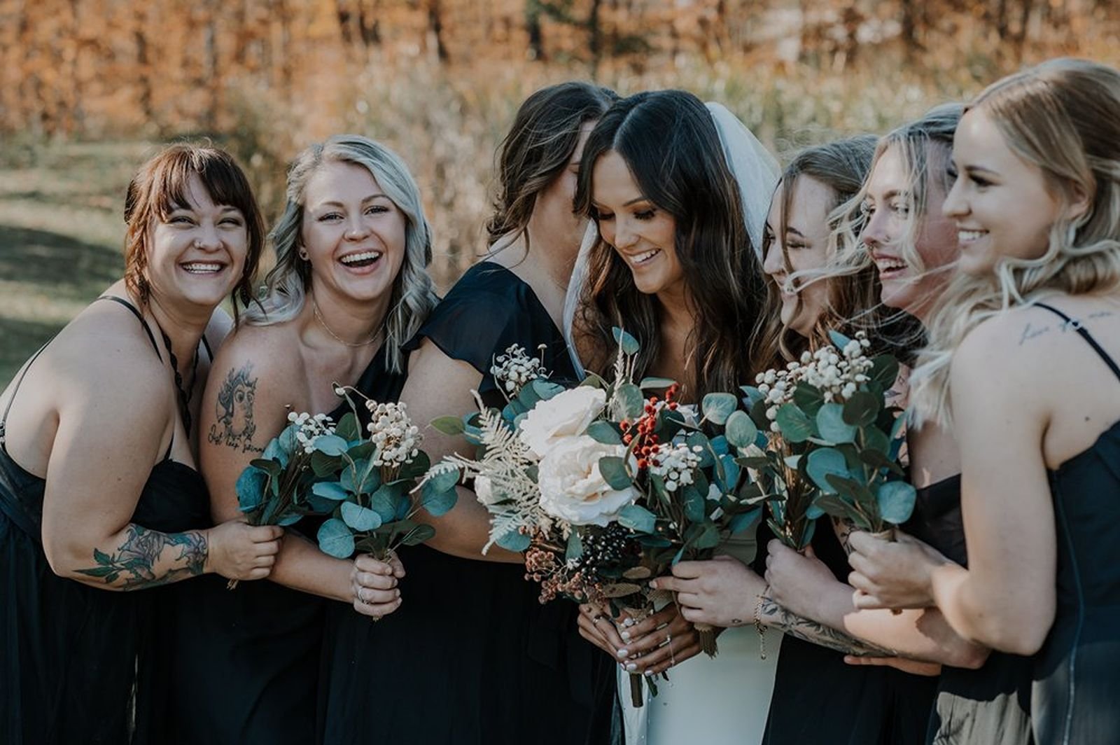 Bride laughing with bridesmaids