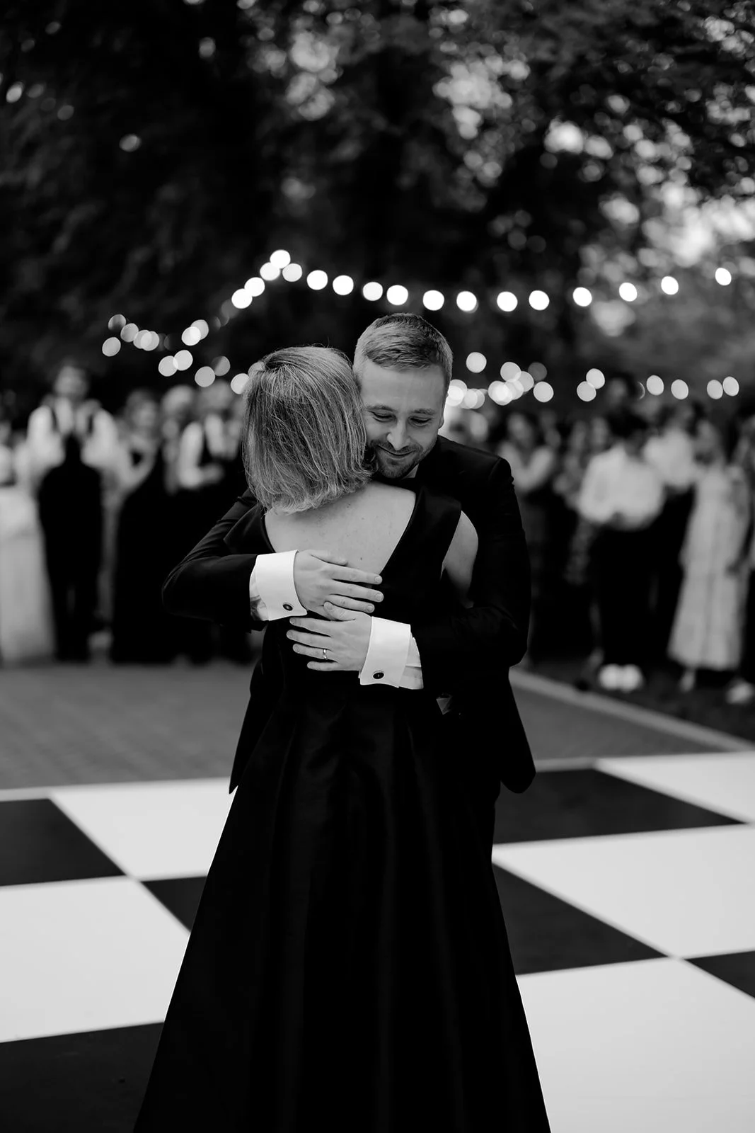 Groom hugs his mom on the dance floor